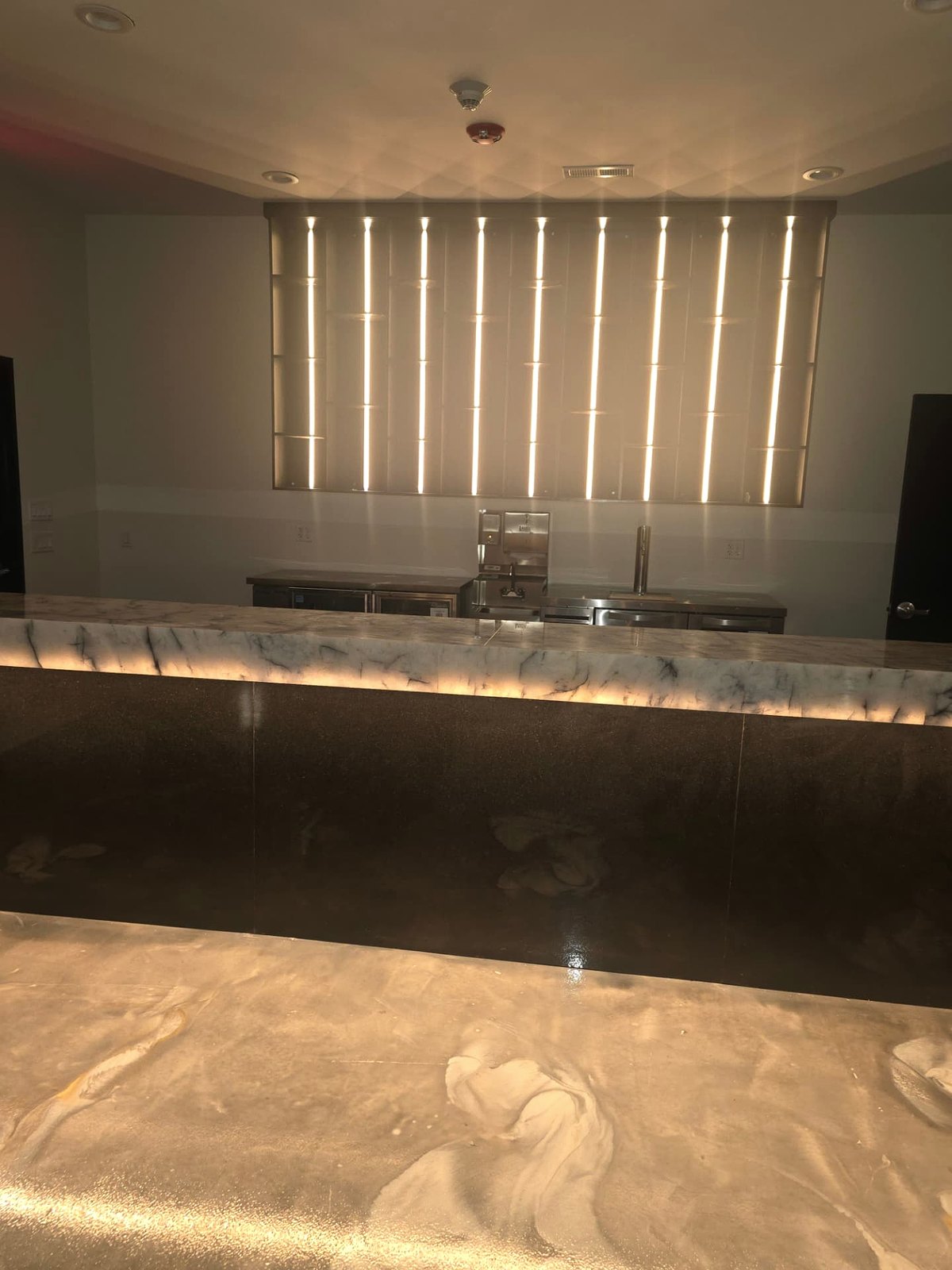Illuminated bamboo feature panel behind a service bar