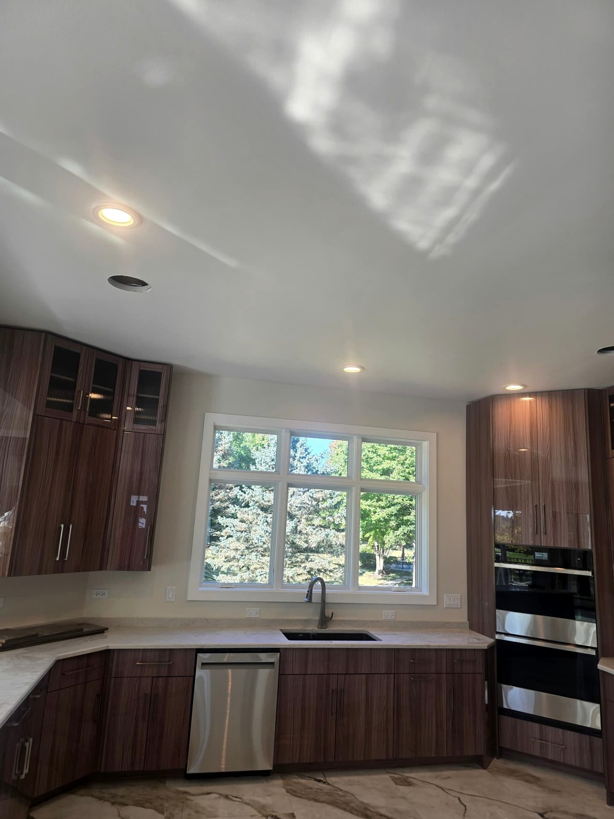 Walnut kitchen with recessed cans and under-cabinet lighting