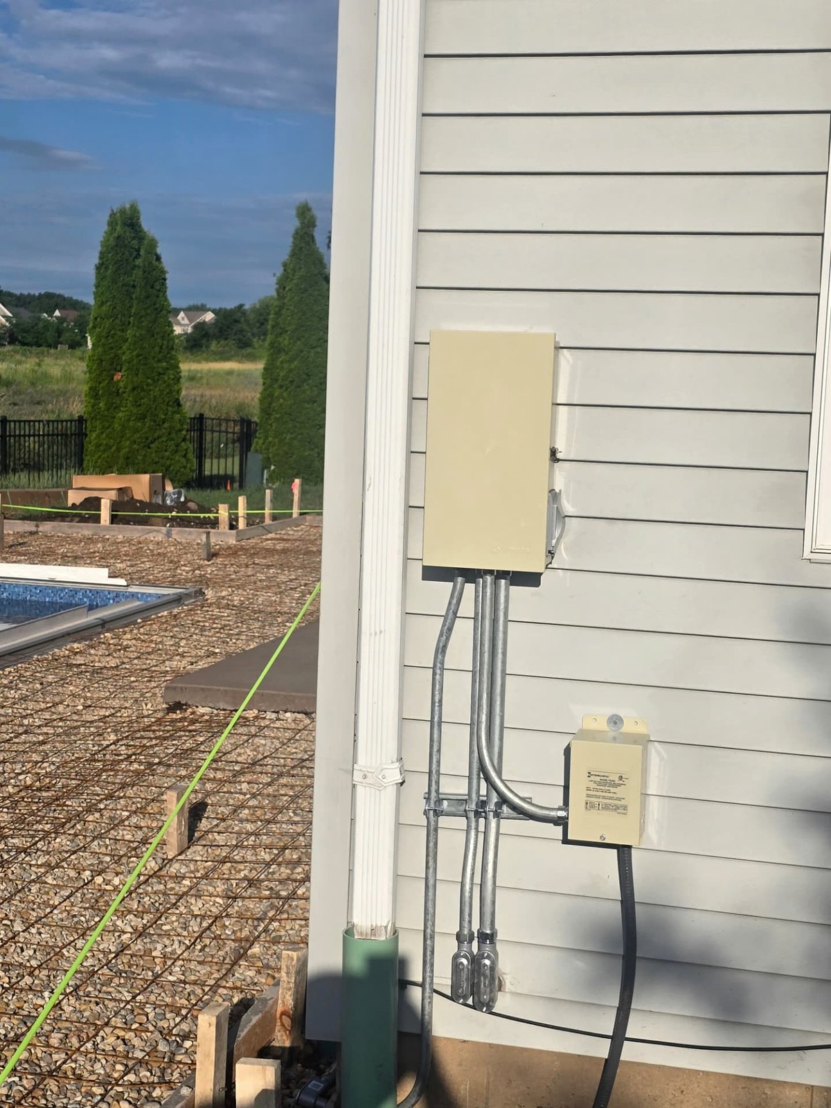 Exterior pool equipment disconnect and timer with rigid conduit runs